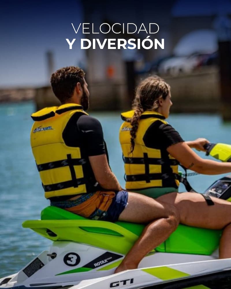Pareja divirtiéndose al alquilar una moto de agua y recorrer la costa de El Puerto de Santa María, Cádiz.